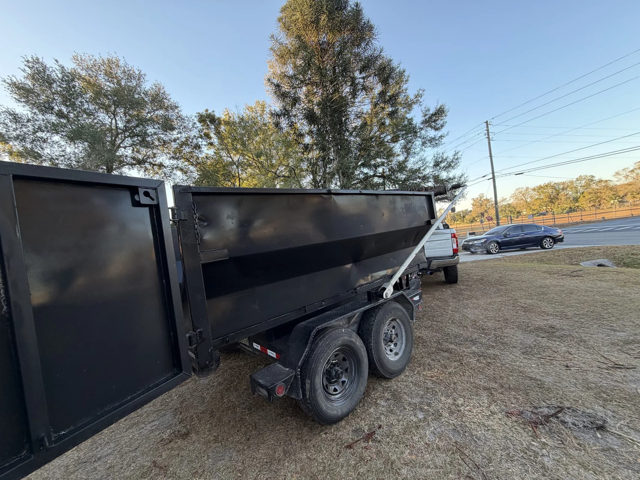 Black 12-yard dumpster side view for size reference